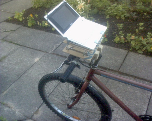 Image of a netbook on bike handlebars