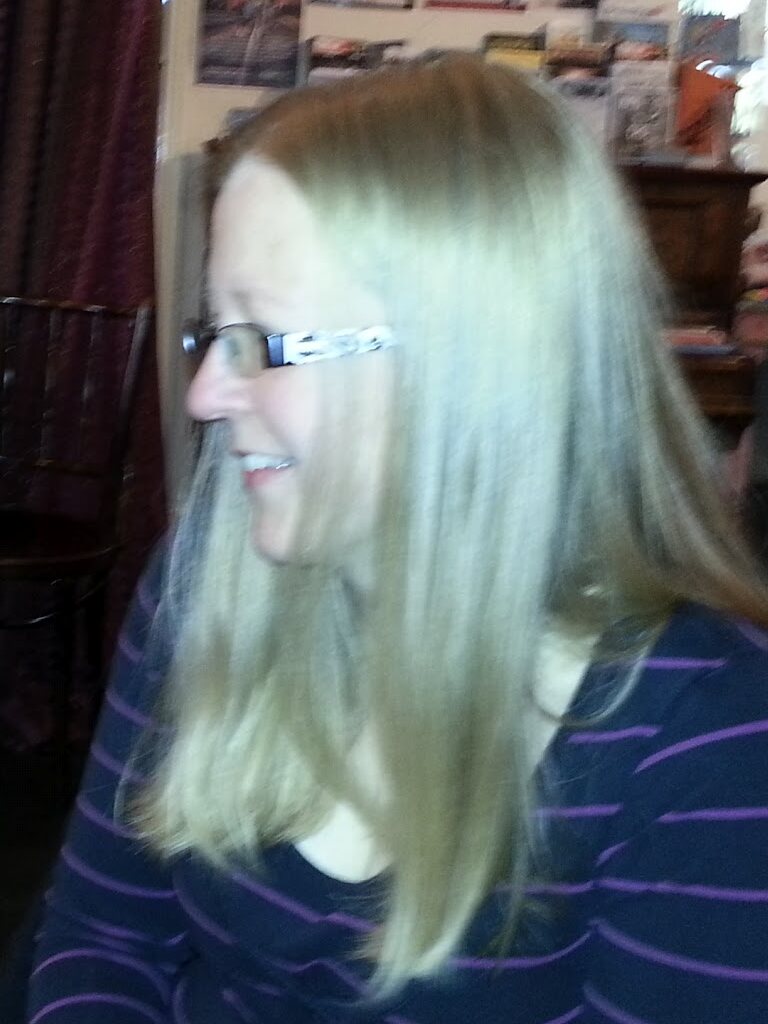 Jutta smiling, seated in a café